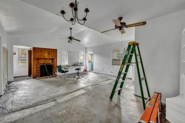 living area with a wealth of natural light, a brick fireplace, vaulted ceiling, and unfinished concrete flooring