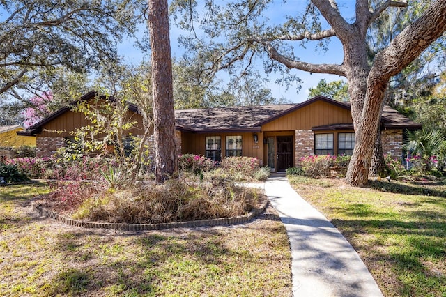 single story home with a front lawn and brick siding