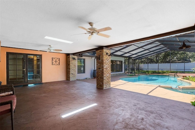 view of swimming pool with decorative columns, a ceiling fan, and a fenced in pool