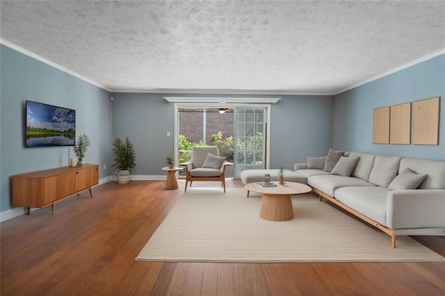 living area featuring hardwood / wood-style flooring, crown molding, baseboards, and a textured ceiling