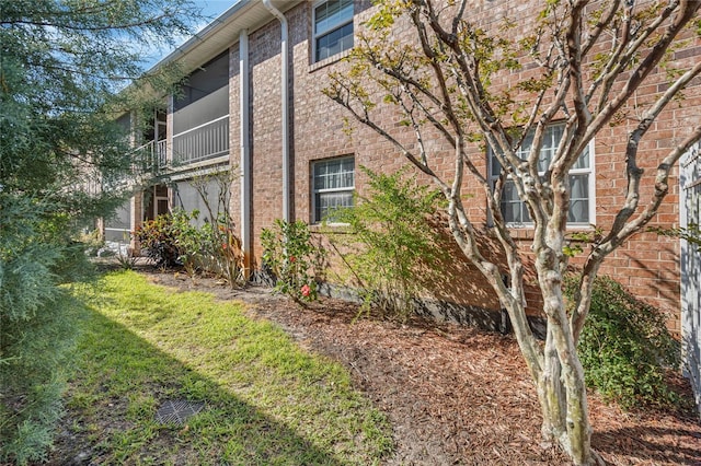 view of side of property with brick siding