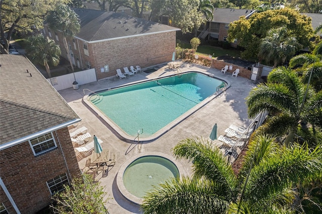 community pool featuring a patio and fence