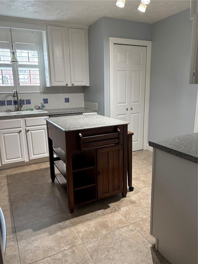 4214 Lake Underhill Rd Unit A, Orlando, FL 32803 - kitchen featuring a sink, open shelves, white cabinets, tasteful backsplash, and light tile patterned floors
