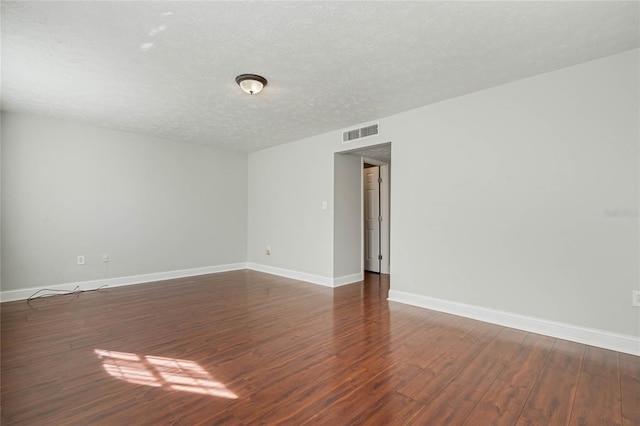 4214 Lake Underhill Rd Unit A, Orlando, FL 32803 - empty room featuring dark wood-style floors, a textured ceiling, and baseboards