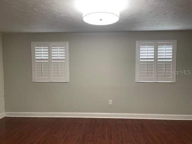 4214 Lake Underhill Rd Unit A, Orlando, FL 32803 - spare room with baseboards, wood finished floors, and a textured ceiling