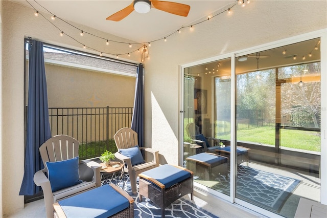 sunroom / solarium with rail lighting and ceiling fan