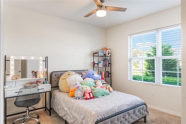 bedroom with ceiling fan, baseboards, and carpet flooring