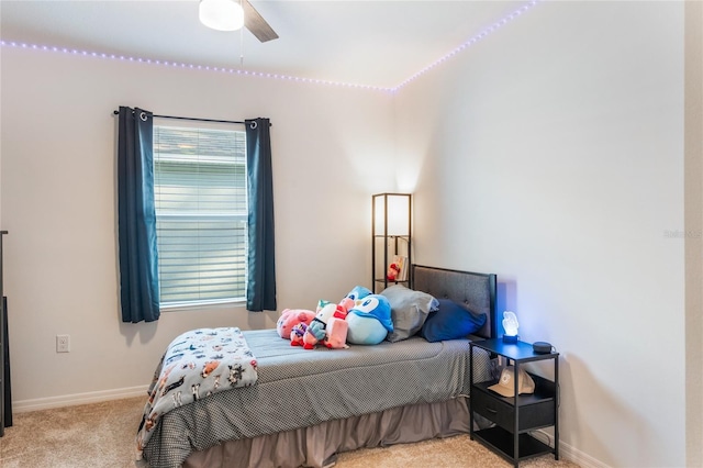 carpeted bedroom featuring a ceiling fan and baseboards