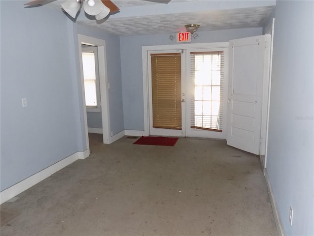 entrance foyer featuring a ceiling fan and baseboards