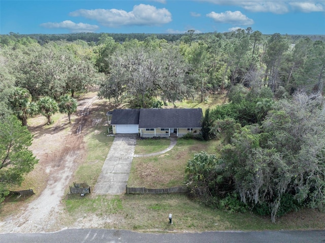 drone / aerial view featuring a forest view