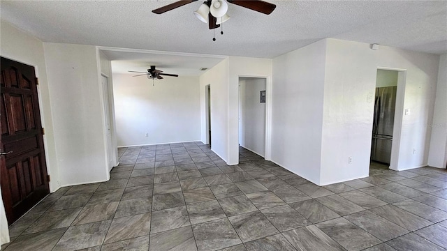 spare room with ceiling fan and a textured ceiling