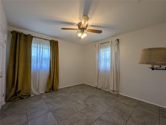 spare room with ceiling fan