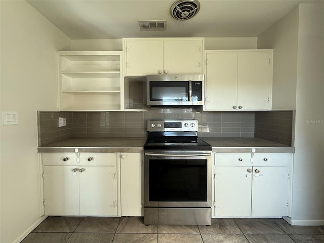 kitchen featuring stainless steel appliances, visible vents, backsplash, and open shelves