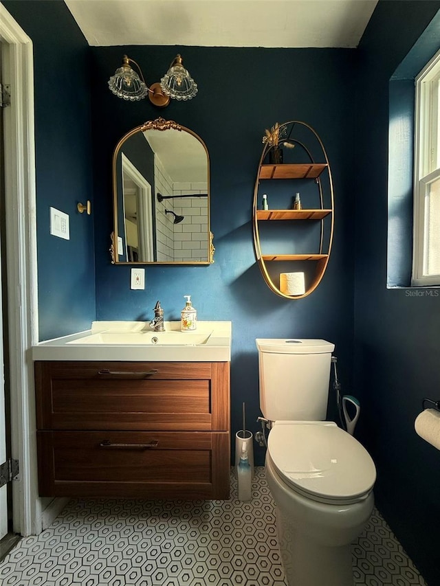 bathroom with toilet, tile patterned floors, and vanity