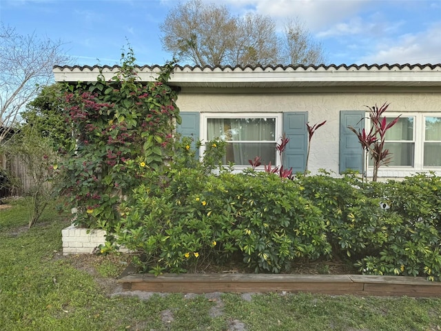 view of side of home with stucco siding