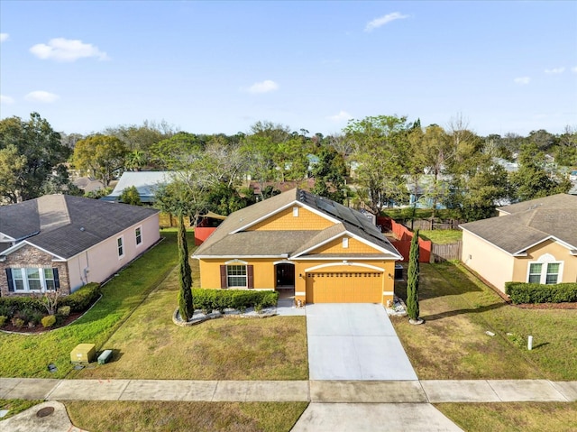 view of front facade with concrete driveway, roof mounted solar panels, a front lawn, and stucco siding