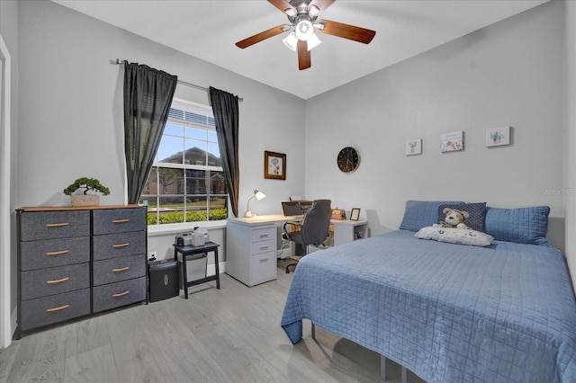 bedroom with light wood-type flooring and a ceiling fan