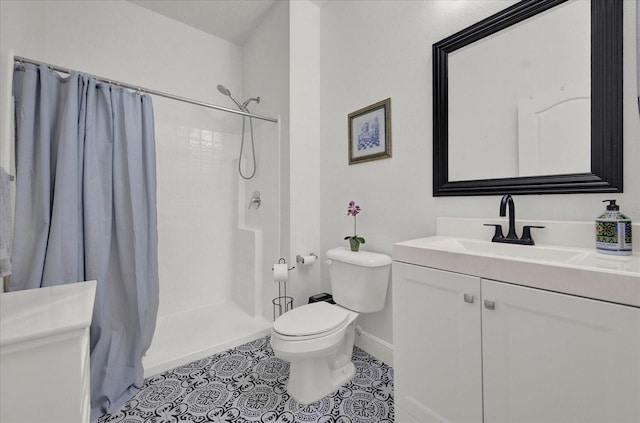 bathroom featuring toilet, vanity, a shower with curtain, baseboards, and tile patterned floors