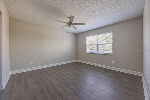 unfurnished room featuring a textured ceiling, ceiling fan, dark wood-type flooring, and baseboards