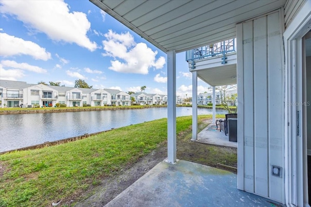 view of patio / terrace with a water view and a residential view