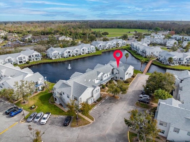 birds eye view of property with a water view and a residential view