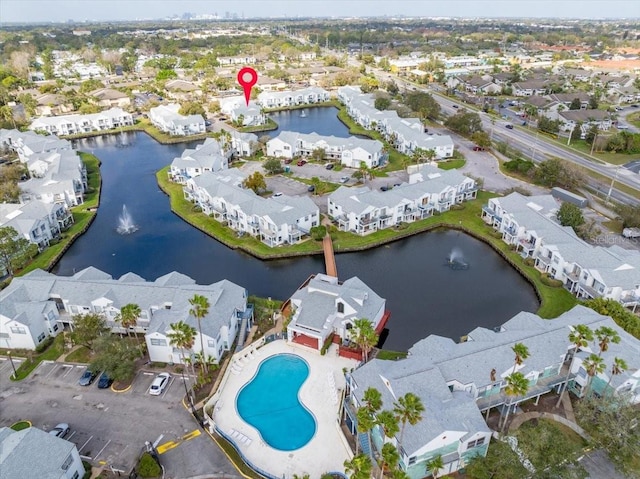 birds eye view of property with a water view and a residential view