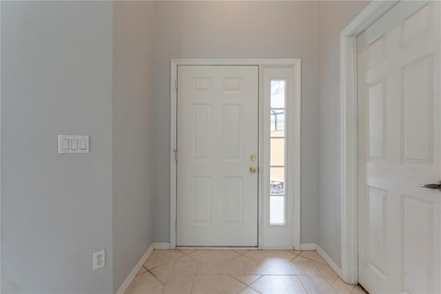 entrance foyer with baseboards and light tile patterned floors