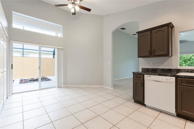 kitchen featuring light tile patterned floors, ceiling fan, arched walkways, dark brown cabinets, and dishwasher