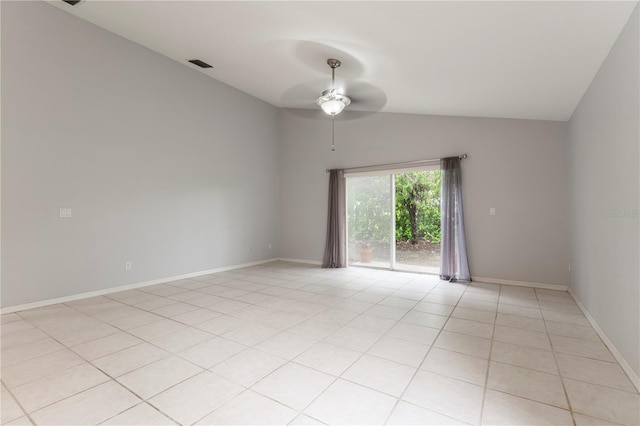 spare room with ceiling fan, light tile patterned floors, visible vents, baseboards, and vaulted ceiling