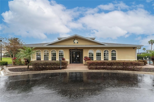 view of front of property featuring french doors and stucco siding