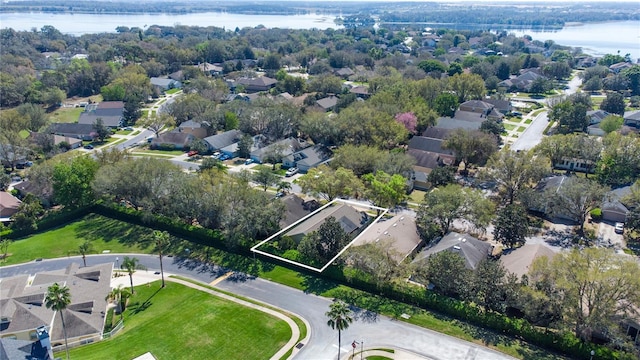 birds eye view of property with a water view and a residential view