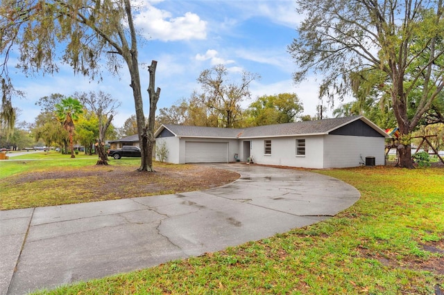 ranch-style house with a garage, central AC, driveway, and a front lawn