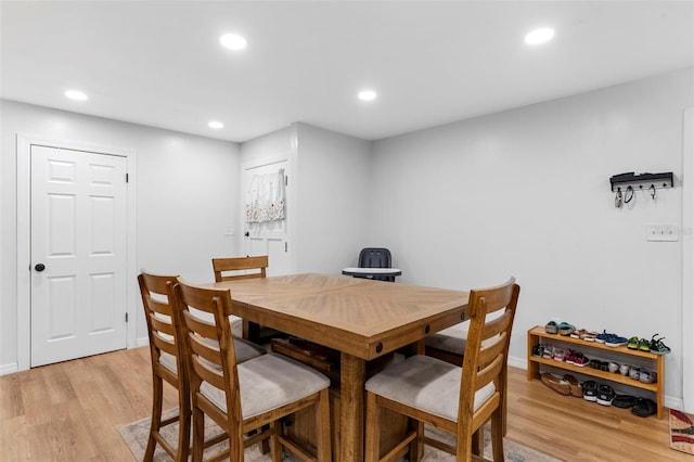 dining space with light wood-type flooring, baseboards, and recessed lighting