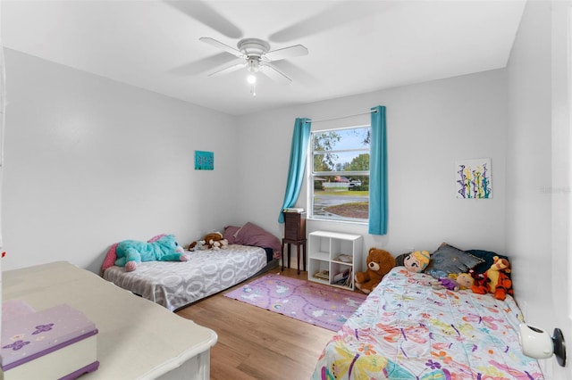 bedroom with a ceiling fan and wood finished floors