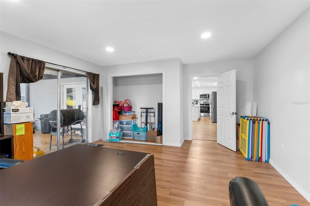 office area with light wood-type flooring, attic access, baseboards, and recessed lighting