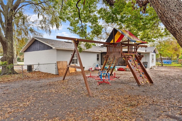 view of play area with central AC unit and fence