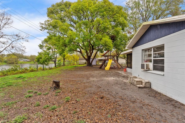 view of yard with a playground and fence