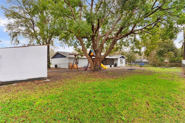 view of yard featuring an outbuilding and fence