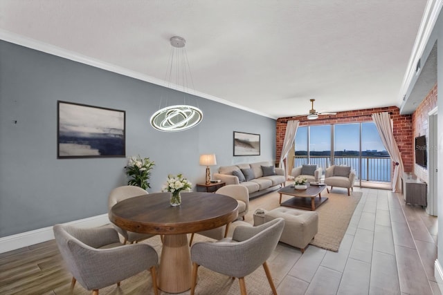 living room with ceiling fan, baseboards, ornamental molding, and light wood-style flooring