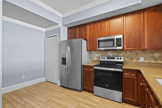 kitchen featuring appliances with stainless steel finishes, light wood-style floors, ornamental molding, and tasteful backsplash