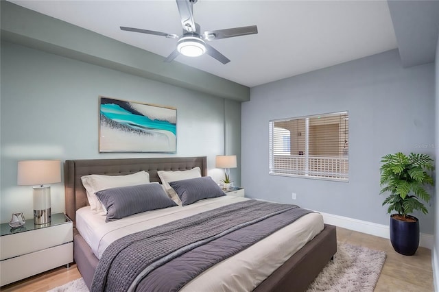 bedroom with ceiling fan and baseboards