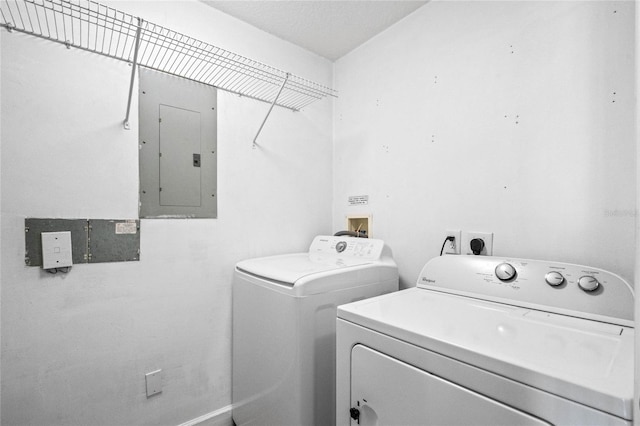 laundry room featuring laundry area, electric panel, and washer and dryer