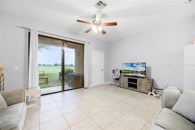 living area with a ceiling fan, visible vents, and light tile patterned floors