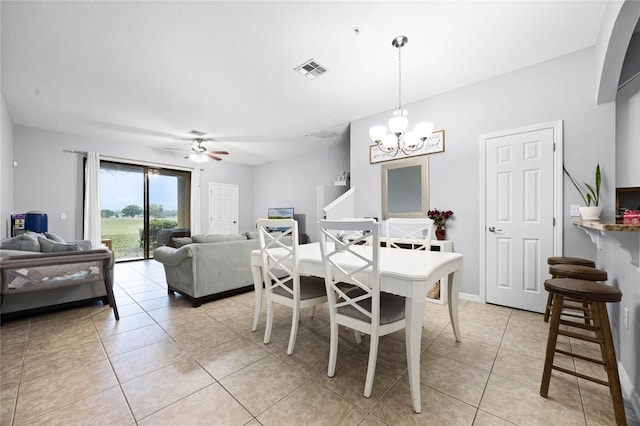 dining space featuring ceiling fan with notable chandelier, light tile patterned flooring, visible vents, and baseboards