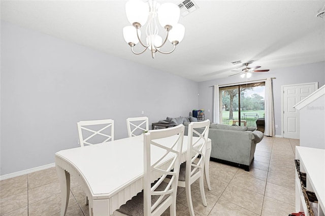 dining room with light tile patterned floors, ceiling fan with notable chandelier, visible vents, and baseboards