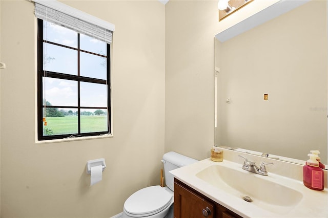 half bathroom featuring toilet and vanity