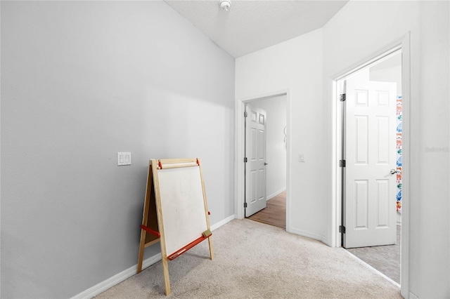 bedroom featuring carpet, a textured ceiling, and baseboards