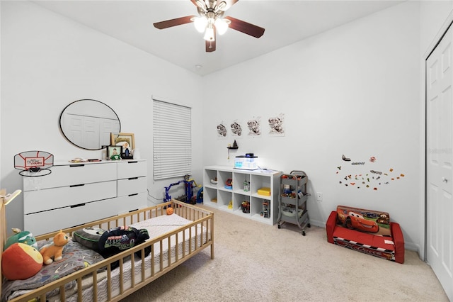 carpeted bedroom with a ceiling fan and a closet