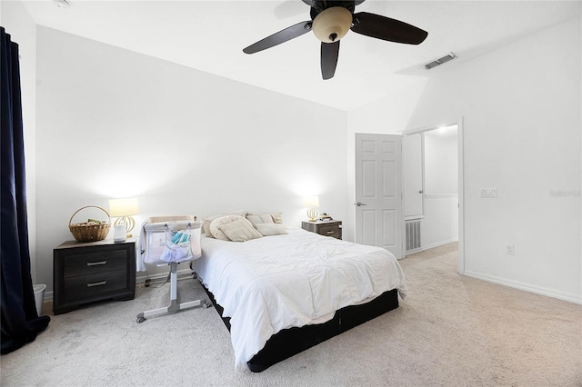 bedroom with ceiling fan, light carpet, visible vents, baseboards, and vaulted ceiling