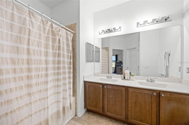 full bath featuring double vanity, a sink, a shower with shower curtain, and tile patterned floors